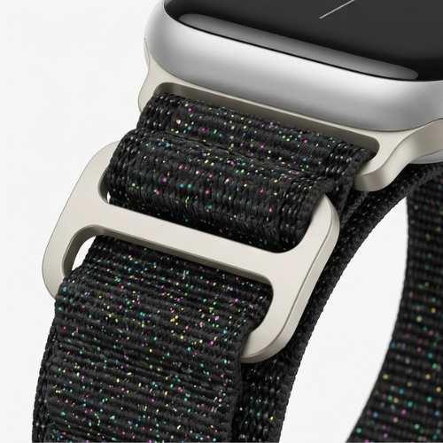 Close-up detail shot of a black woven nylon Apple Watch sport loop band with silver metal buckle clasp, highlighting the fabric texture and speckled weave pattern