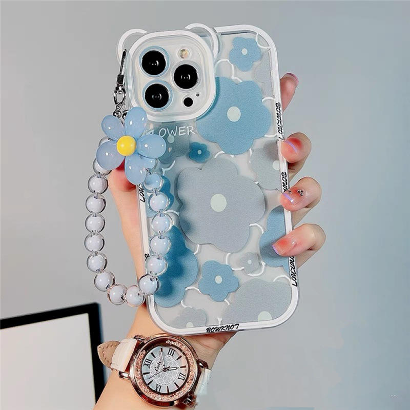 A woman displays a blue flower case with a watch and bracelet, showcasing products from grunxstore.