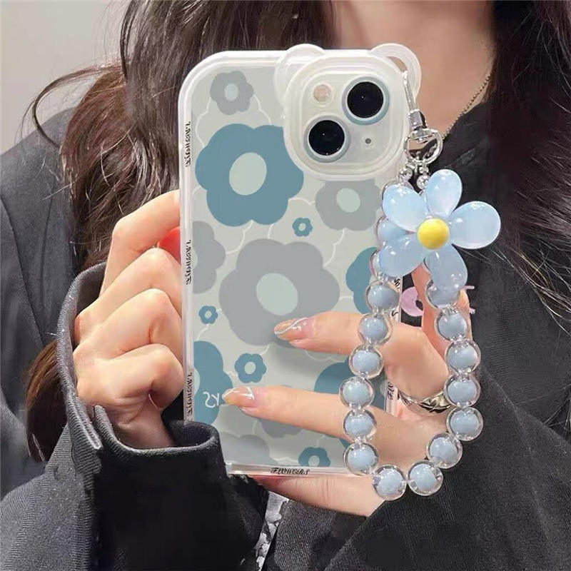 A woman displays a blue flower case with a watch and bracelet, showcasing products from grunxstore.