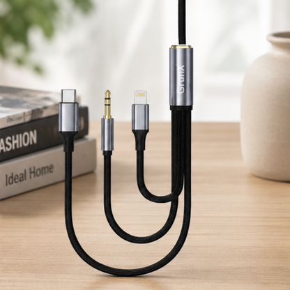 3-in-1 AUX cable with three connectors displayed on a wooden surface