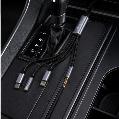 3-in-1 AUX cable plugged into a car center console audio port