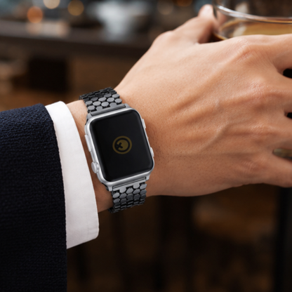 Close-up of a person in a white dress shirt and suit adjusting Apple Watch with silver stainless steel jubilee link band on their wrist