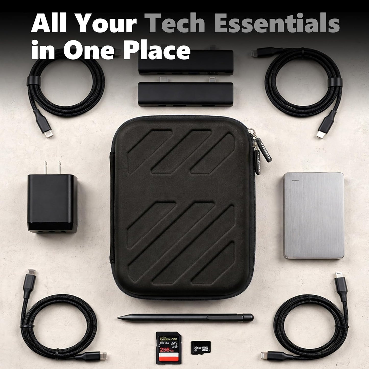 hard case for tech essentials surrounded by charging cables, USB hub, portable SSD, charger, stylus, and memory cards