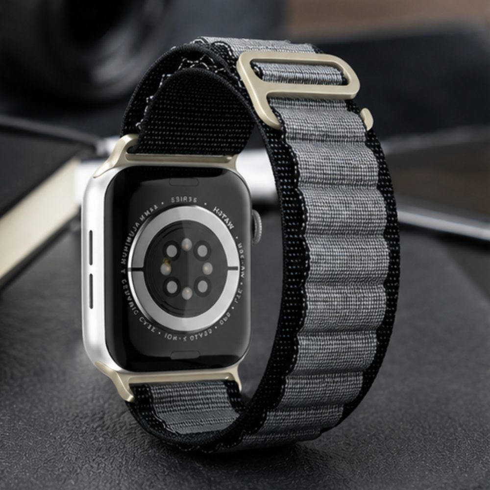 Rear view of Apple Watch Ultra with charcoal grey woven alpine loop band, showing the back sensor and band attachment