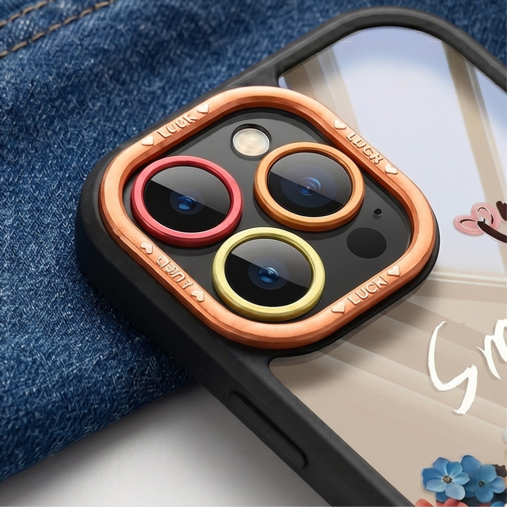 Transparent floral iPhone case with multicolor dried flowers, "Smile" text design, and rose gold camera ring on marble surface with gold rings
