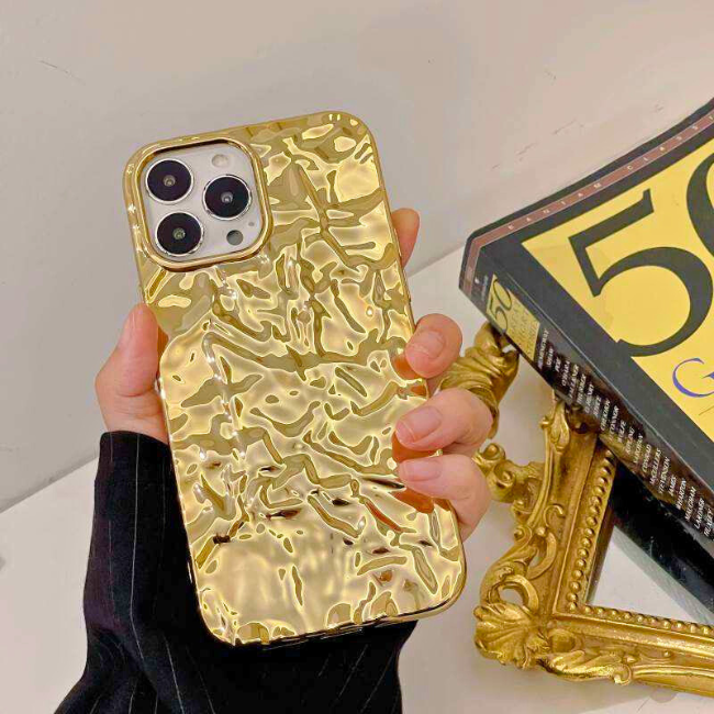 Gold iPhone case with a glossy finish, available for purchase on Grunxstore, highlighting its stylish design.
