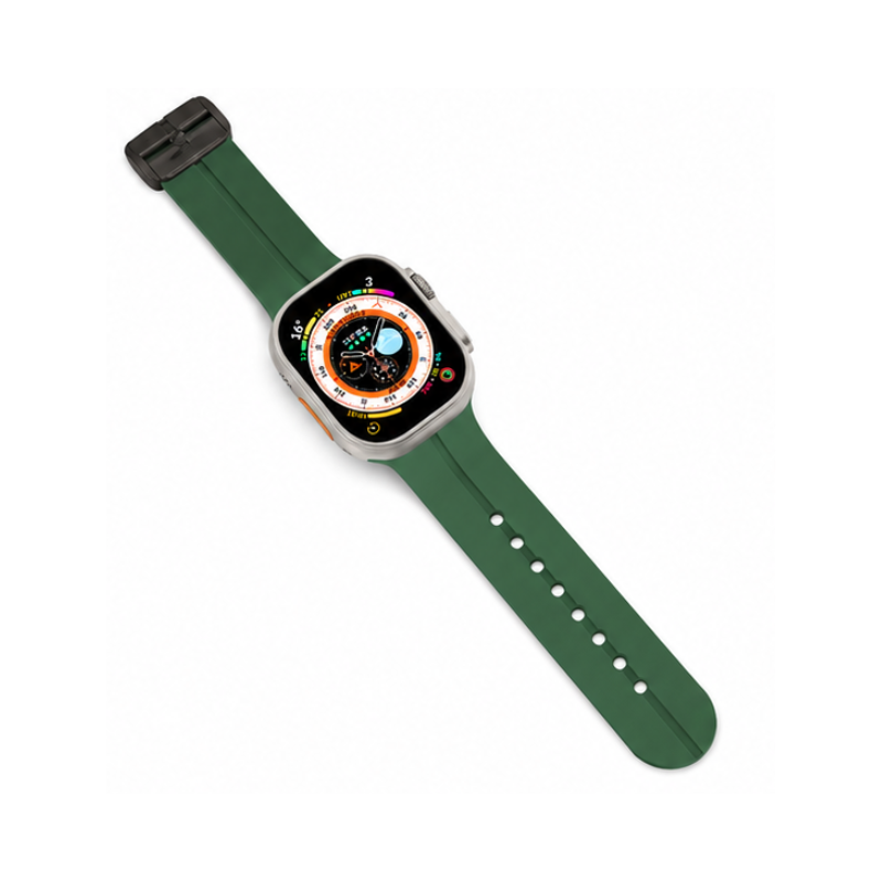 Side profile product view of Apple Watch with detached forest green silicone sport band on a white background, showing band pin details