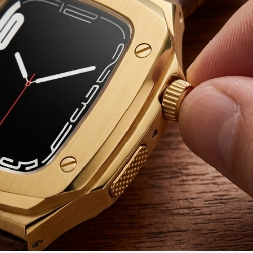 Close-up of Apple Watch with gold case and black dial being held, highlighting the premium gold case edge and side button detail