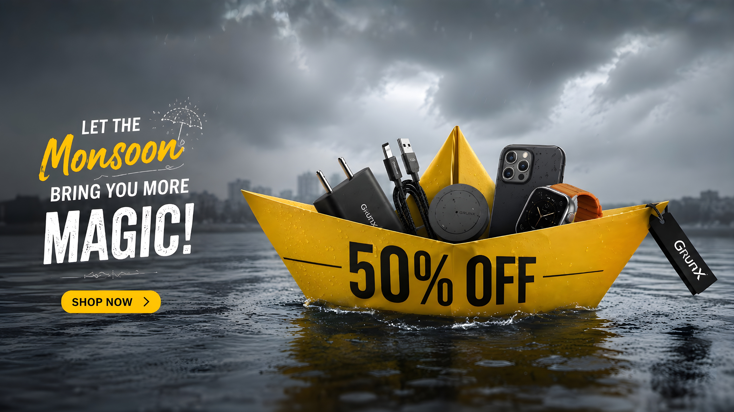 GrunX Monsoon Sale banner featuring a yellow paper boat floating on rainwater with premium mobile accessories including a fast charger, USB cables, wireless charger, iPhone, and smartwatch, highlighting up to 50% off offers during the monsoon season.