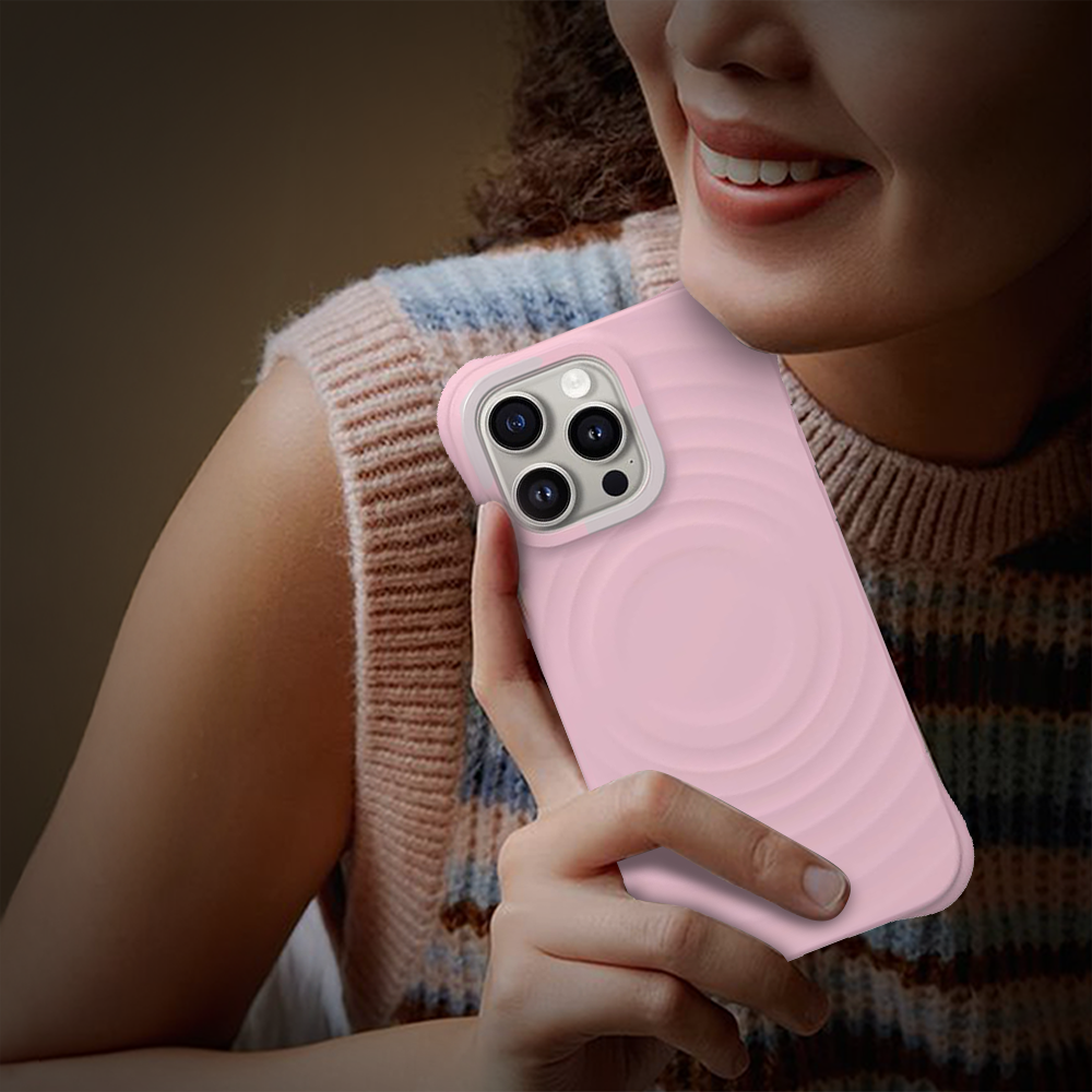  A woman holds an iPhone 11 case featuring a pink circle, showcasing stylish phone accessories from grunxstore.com.
