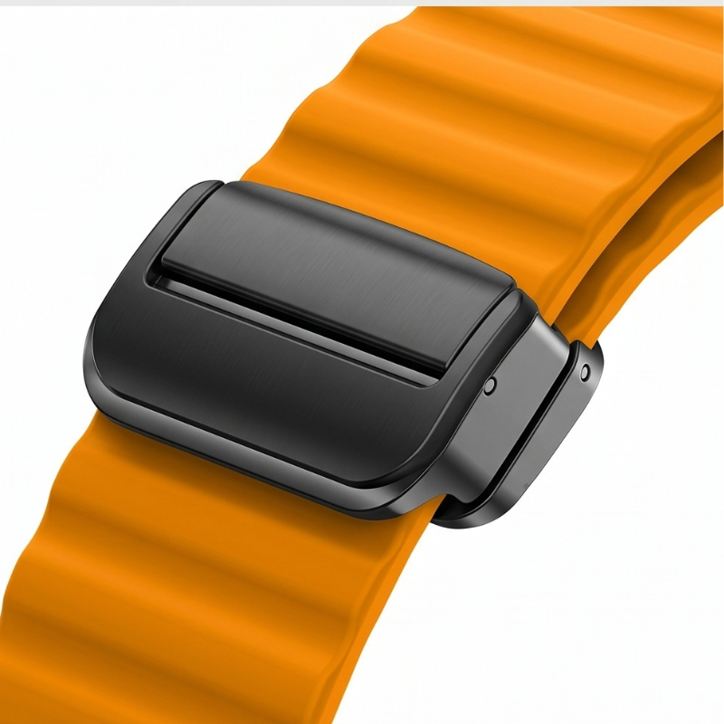 Close-up of the orange ocean wave silicone band showing the ridged texture and dark grey titanium magnetic loop clasp detail