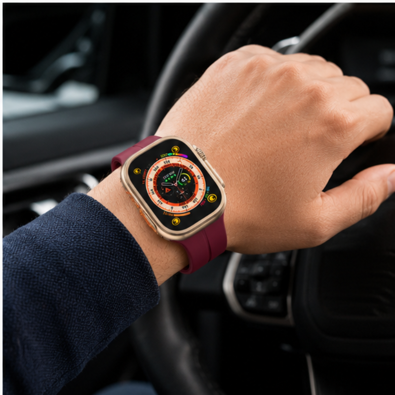 Person wearing Apple Watch Ultra with burgundy magnetic silicone loop band while holding a car steering wheel