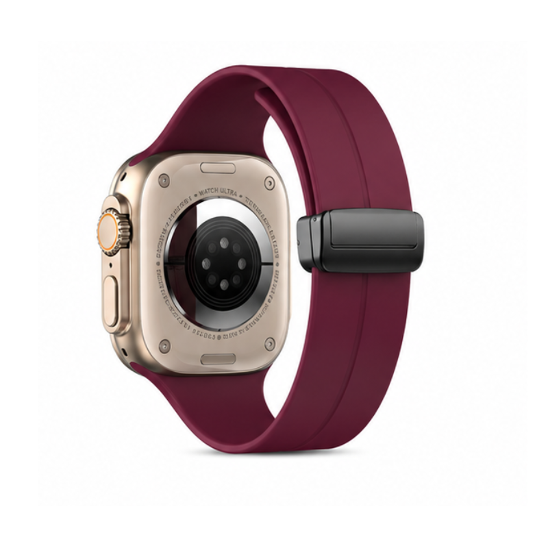Side product view of Apple Watch Ultra with gold case and burgundy magnetic silicone loop band on a white background, showing the magnetic folding clasp