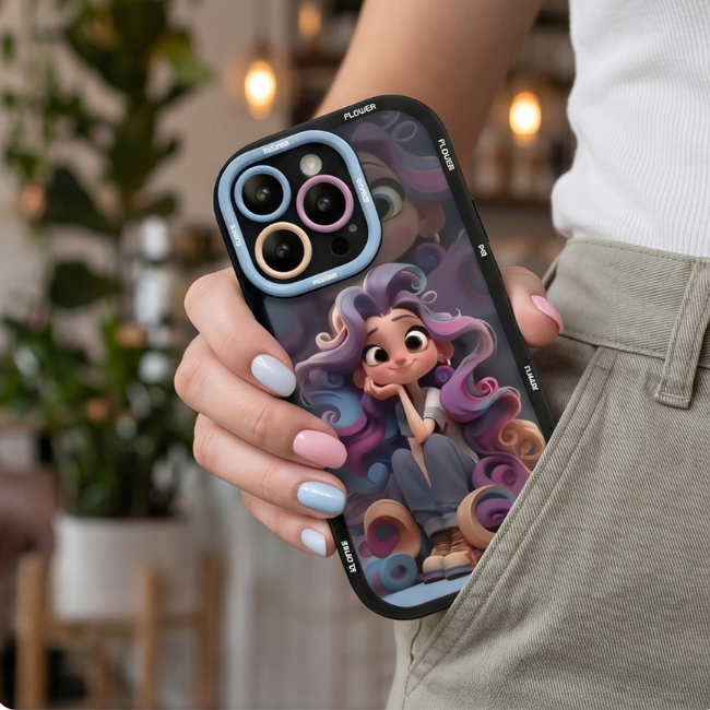 Animated character iPhone case with blue protective camera ring held in hand outdoors, showcasing vibrant cartoon girl design with nature background