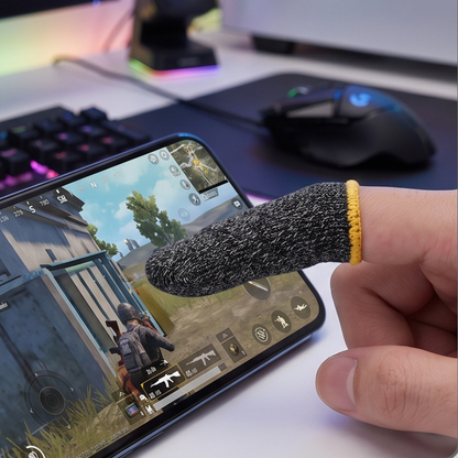 Pro gaming finger sleeve worn on thumb while playing PUBG mobile on smartphone at gaming setup