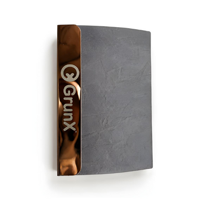 GrunX dark gray textured hardcover notebook with copper rose gold metallic spine and embossed logo side view