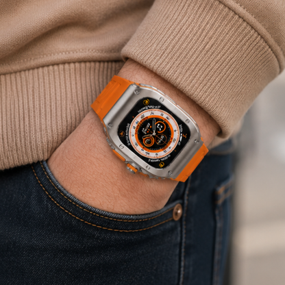 Person in jeans and a beige top wearing Apple Watch Ultra with titanium case mod kit and orange rubber sport band on their wrist