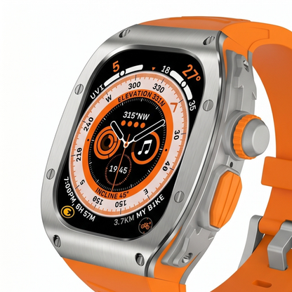 Front product view of Apple Watch Ultra with titanium protective case mod kit and orange rubber sport band showing the compass watch face on a white background
