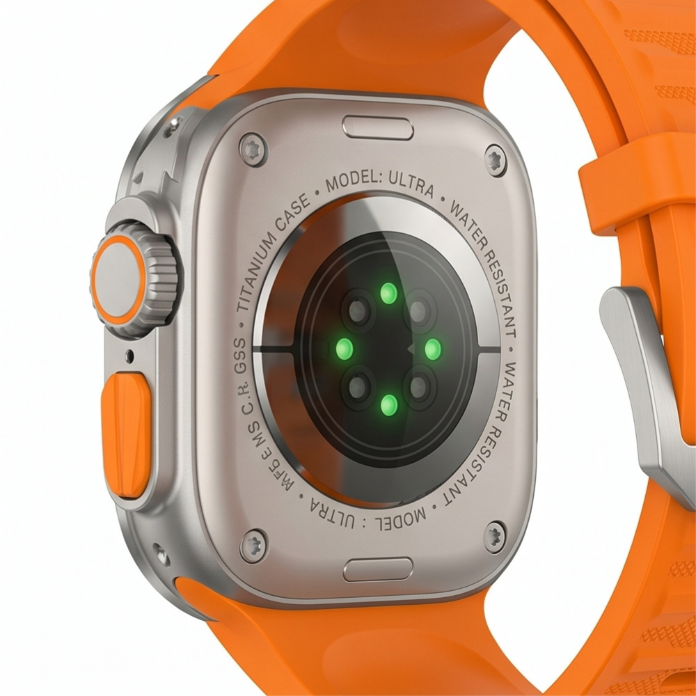Rear view of Apple Watch Ultra with titanium protective case mod kit and orange rubber sport band showing the green back sensors on a white background