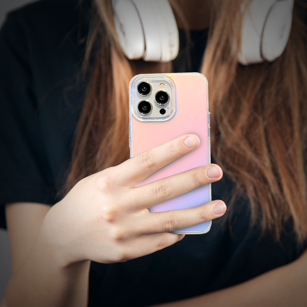 A woman wearing headphones holds an iPhone 11, showcasing her style and tech-savvy look.
