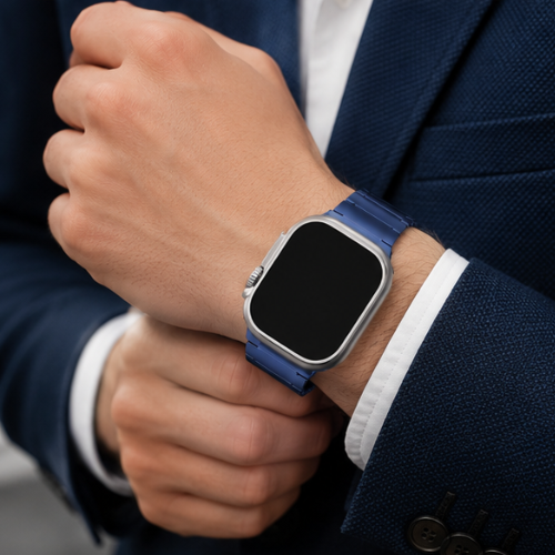 Close-up of a man in a navy blue suit wearing Apple Watch Ultra with blue stainless steel link band, adjusting the watch on his wrist