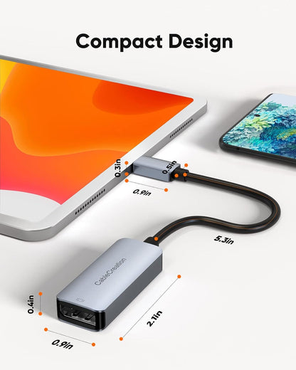 Compact USB C to DisplayPort adapter with braided cable connected to iPad showing dimensions 2.1 x 0.9 x 0.4 inch