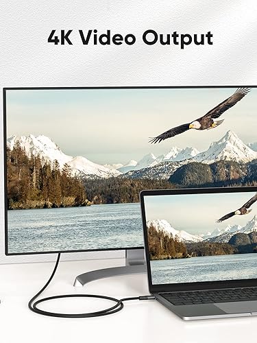 USB-C to USB-C cable supporting 4K video output connecting laptop to large external monitor displaying ultra HD nature scenery