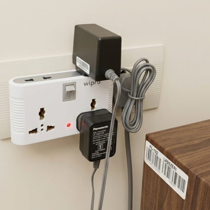 Wipro 4 Way Multiplug Adaptor mounted on wall socket with multiple chargers plugged in showing universal socket compatibility