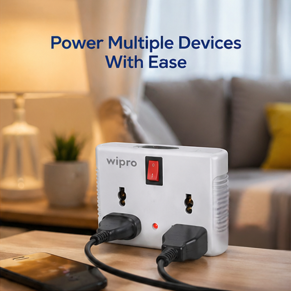 Wipro 4 Way Multiplug Adaptor powering multiple devices simultaneously on living room table with red switch indicator