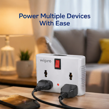 Wipro 4 Way Multiplug Adaptor powering multiple devices simultaneously on living room table with red switch indicator